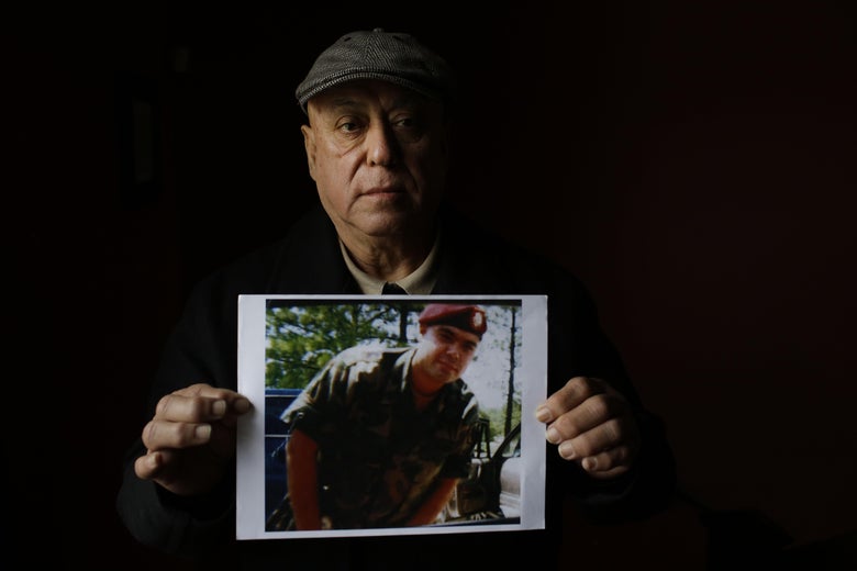 Miguel Perez poses as he holds a photo of his son Miguel Perez Jr., on April 4, 2017 in Chicago, Illinois.